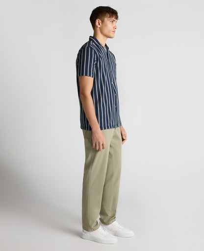 Man wearing a navy Tapered Fit Striped Cotton-Blend Shirt