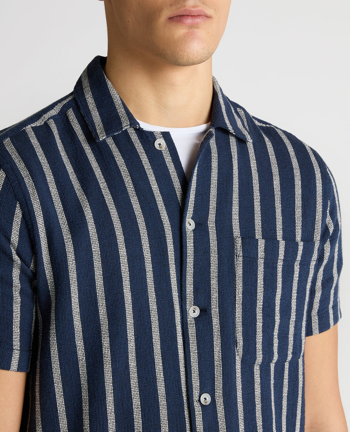 Man wearing a navy Tapered Fit Striped Cotton-Blend Shirt