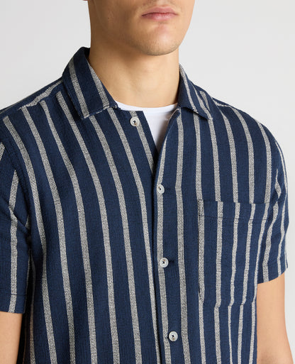 Man wearing a navy Tapered Fit Striped Cotton-Blend Shirt