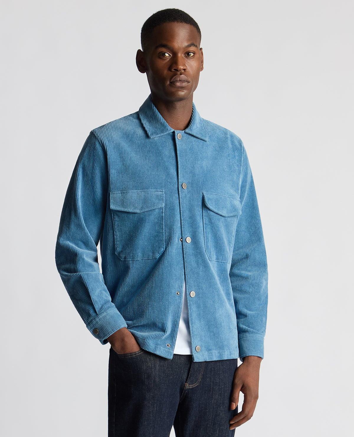 Man wearing a blue Tapered Fit Corduroy Overshirt