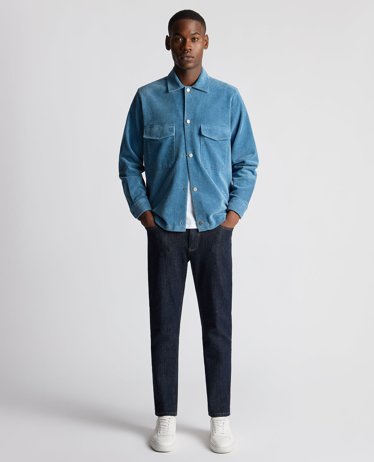 Man wearing a blue Tapered Fit Corduroy Overshirt