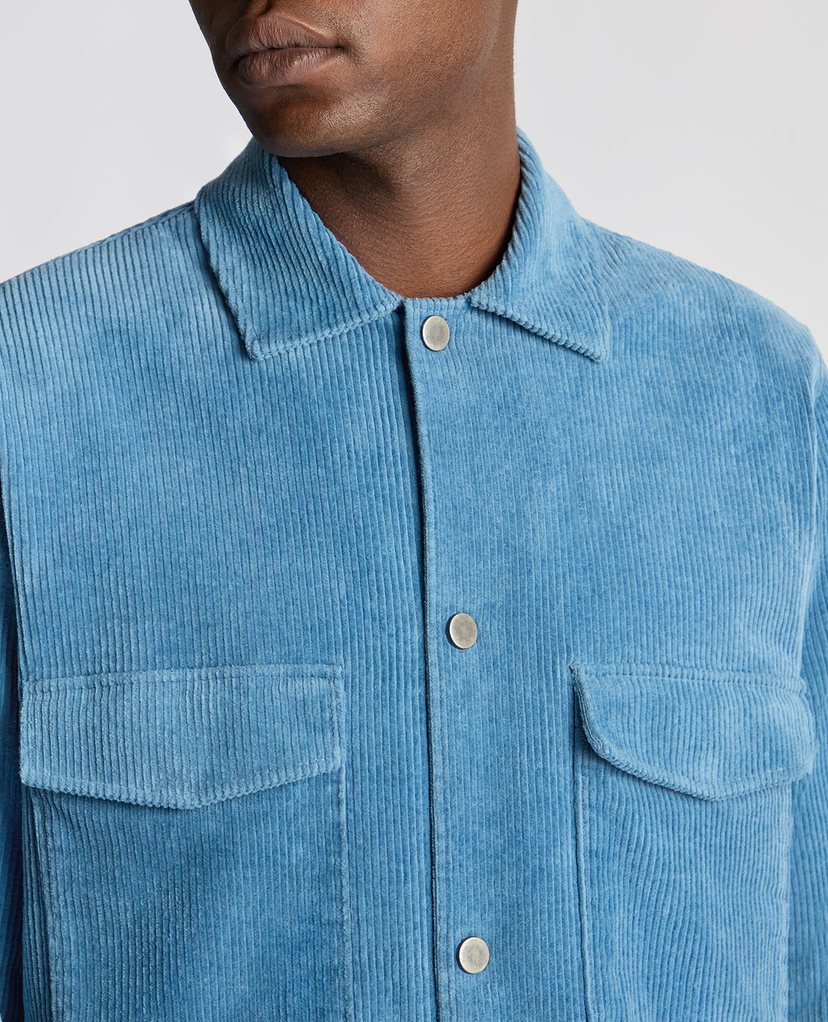 Man wearing a blue Tapered Fit Corduroy Overshirt