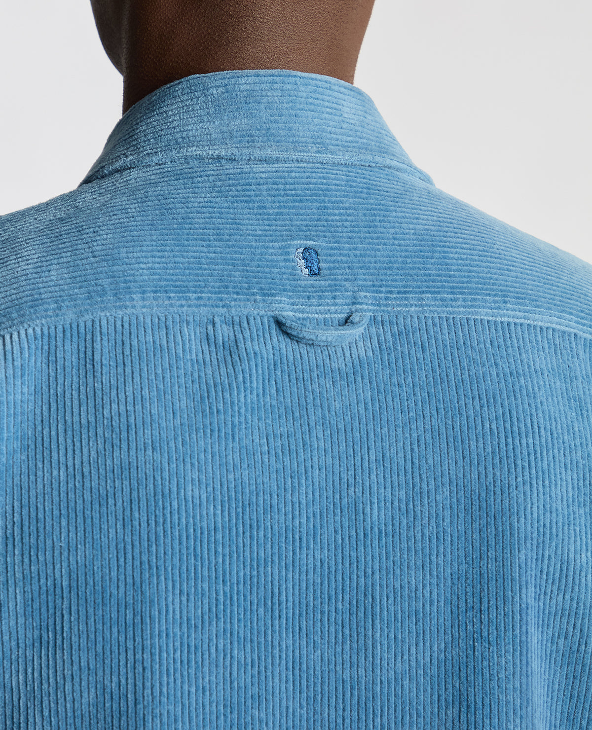 Man wearing a blue Tapered Fit Corduroy Overshirt