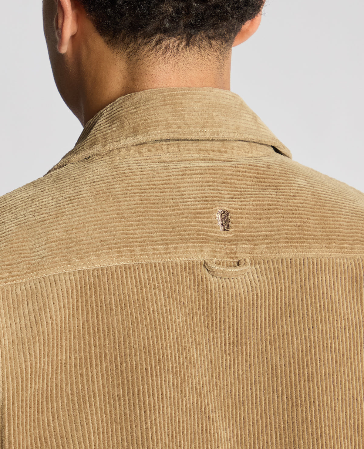 Man wearing a sand Tapered Fit Corduroy Overshirt