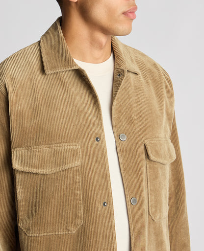 Man wearing a sand Tapered Fit Corduroy Overshirt