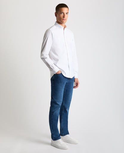 Man wearing a white Tapered Fit Oxford Cotton Shirt