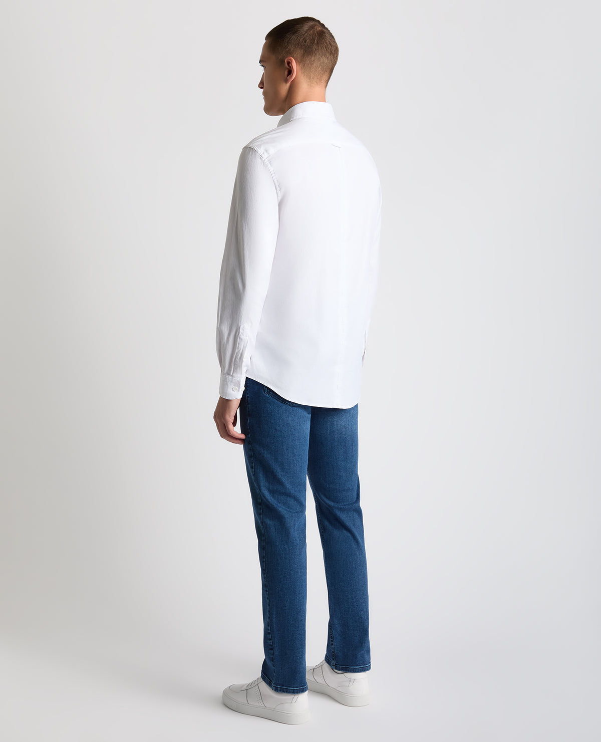 Man wearing a white Tapered Fit Oxford Cotton Shirt