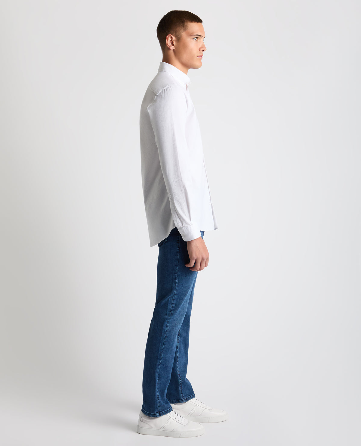 Man wearing a white Tapered Fit Oxford Cotton Shirt