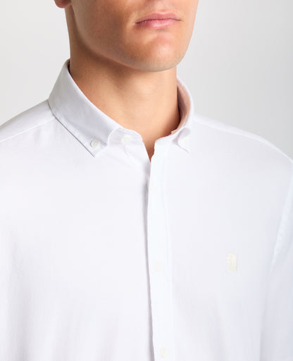 Man wearing a white Tapered Fit Oxford Cotton Shirt