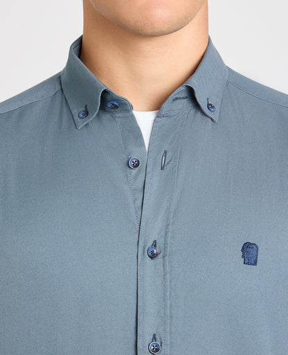 Man wearing a blue casual shirt