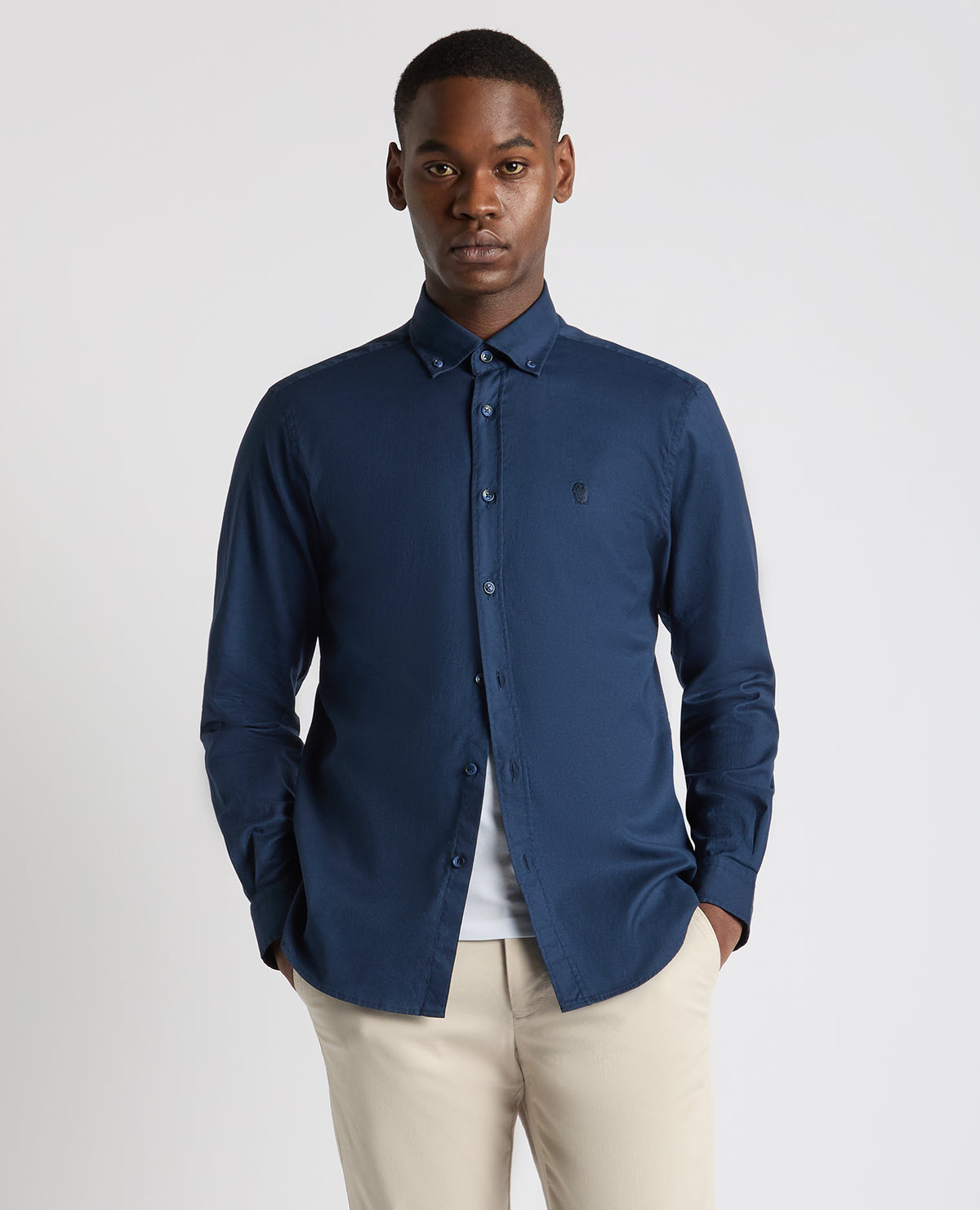 Man wearing a navy Tapered Fit Oxford Cotton Shirt