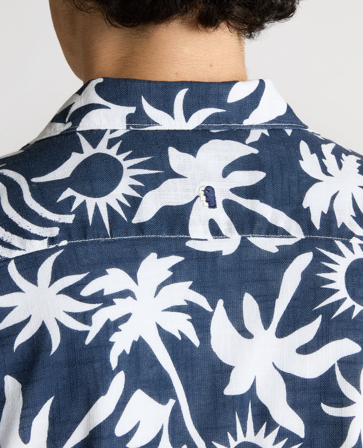 Man wearing a navy Tapered Fit Floral Print Cotton Shirt