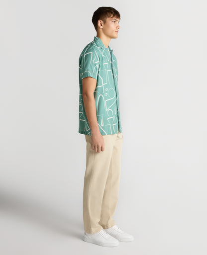 Man wearing a green Relaxed Fit Linen-Blend Abstract Print Shirt
