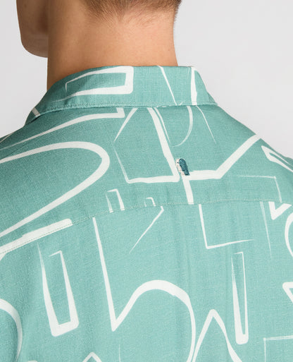 Man wearing a green Relaxed Fit Linen-Blend Abstract Print Shirt