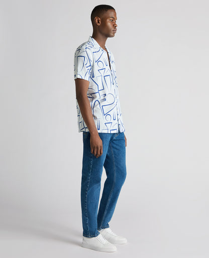 Man wearing a blue Relaxed Fit Linen-Blend Abstract Print Shirt