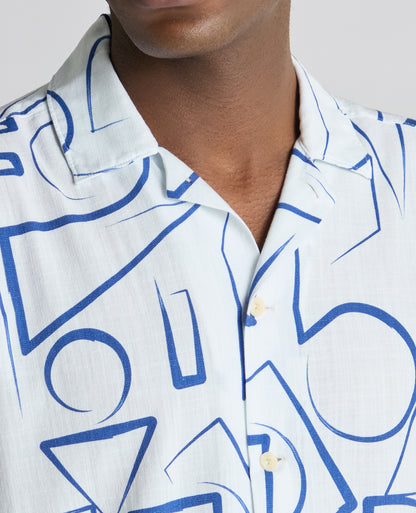 Man wearing a blue Relaxed Fit Linen-Blend Abstract Print Shirt