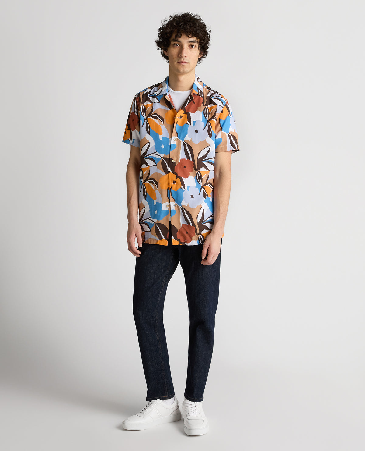 Man wearing a blue Tapered Fit Tencel Floral Print shirt