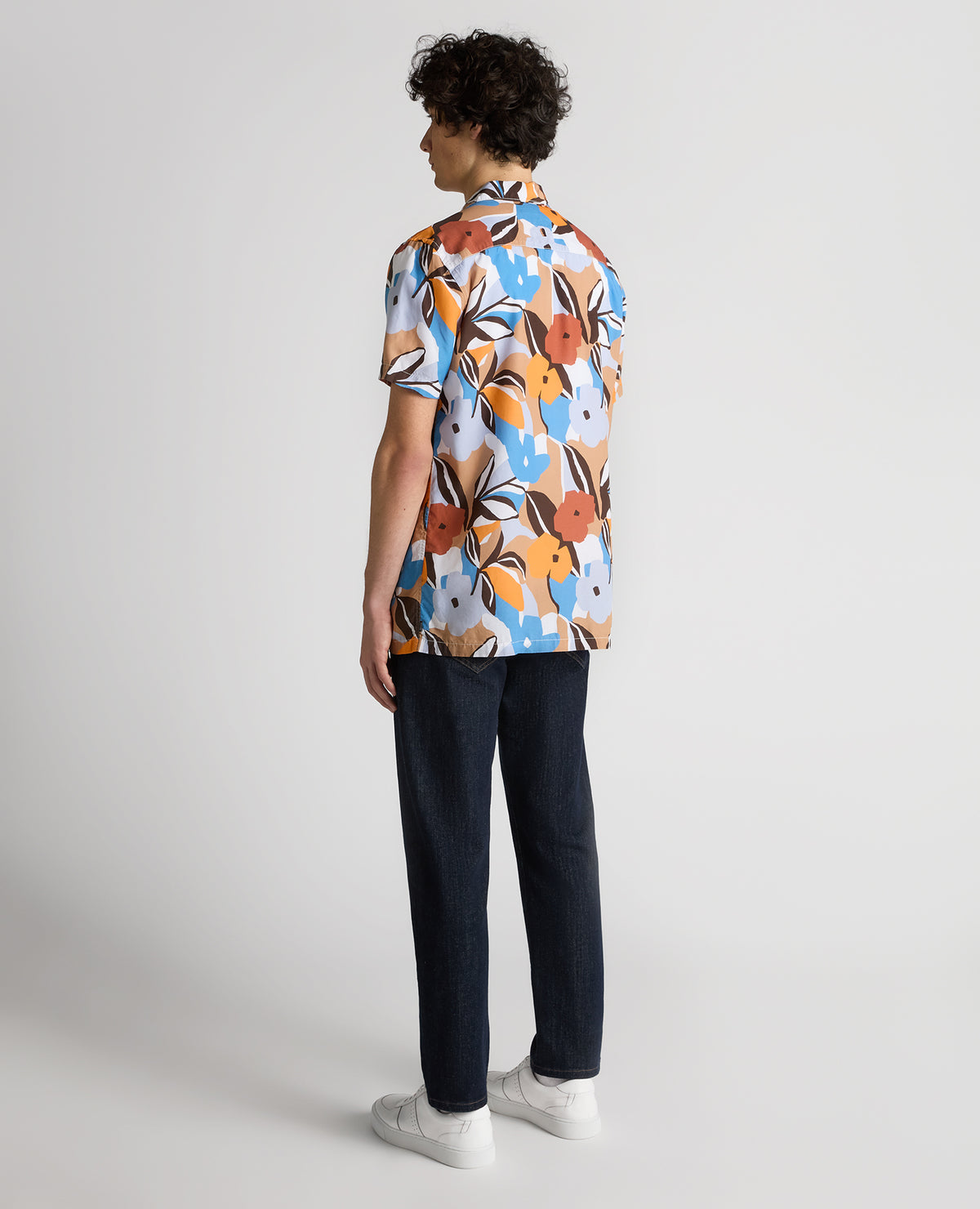 Man wearing a blue Tapered Fit Tencel Floral Print shirt
