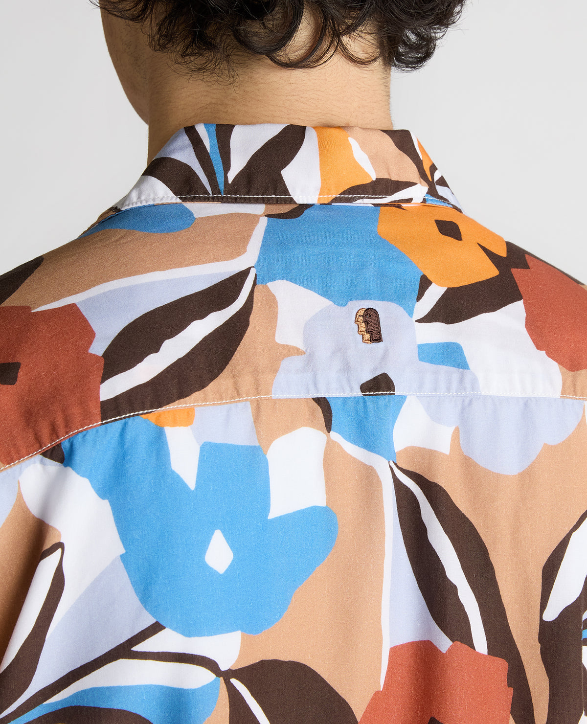Man wearing a blue Tapered Fit Tencel Floral Print shirt