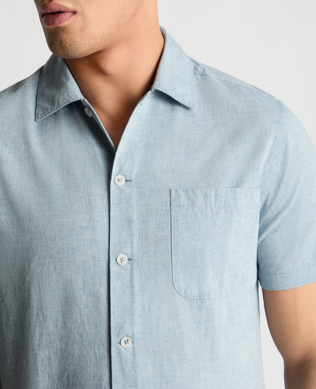 Man wearing a blue casual shirt