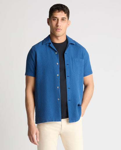 Man wearing a blue casual shirt