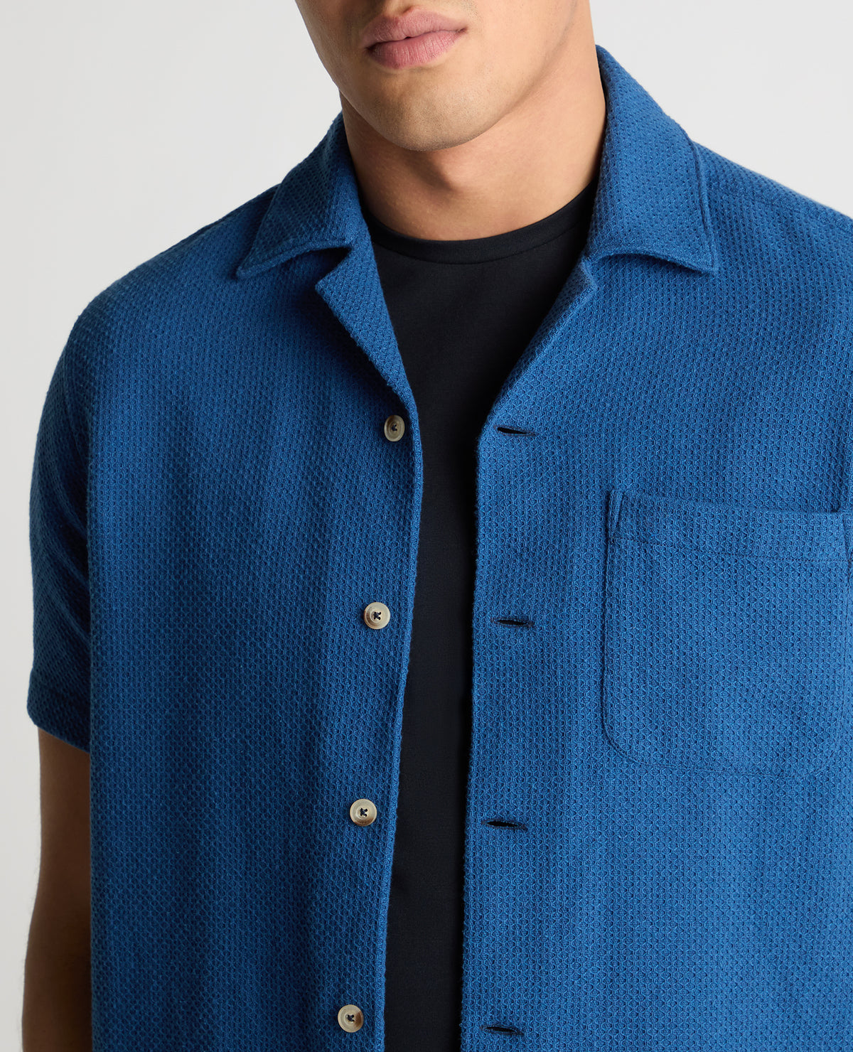 Man wearing a blue casual shirt