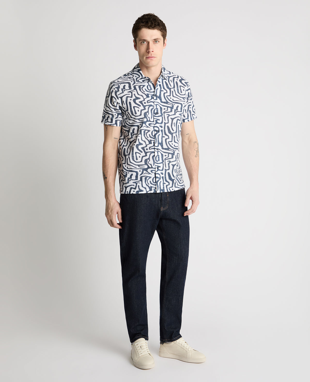Man wearing a white and navy casual shirt
