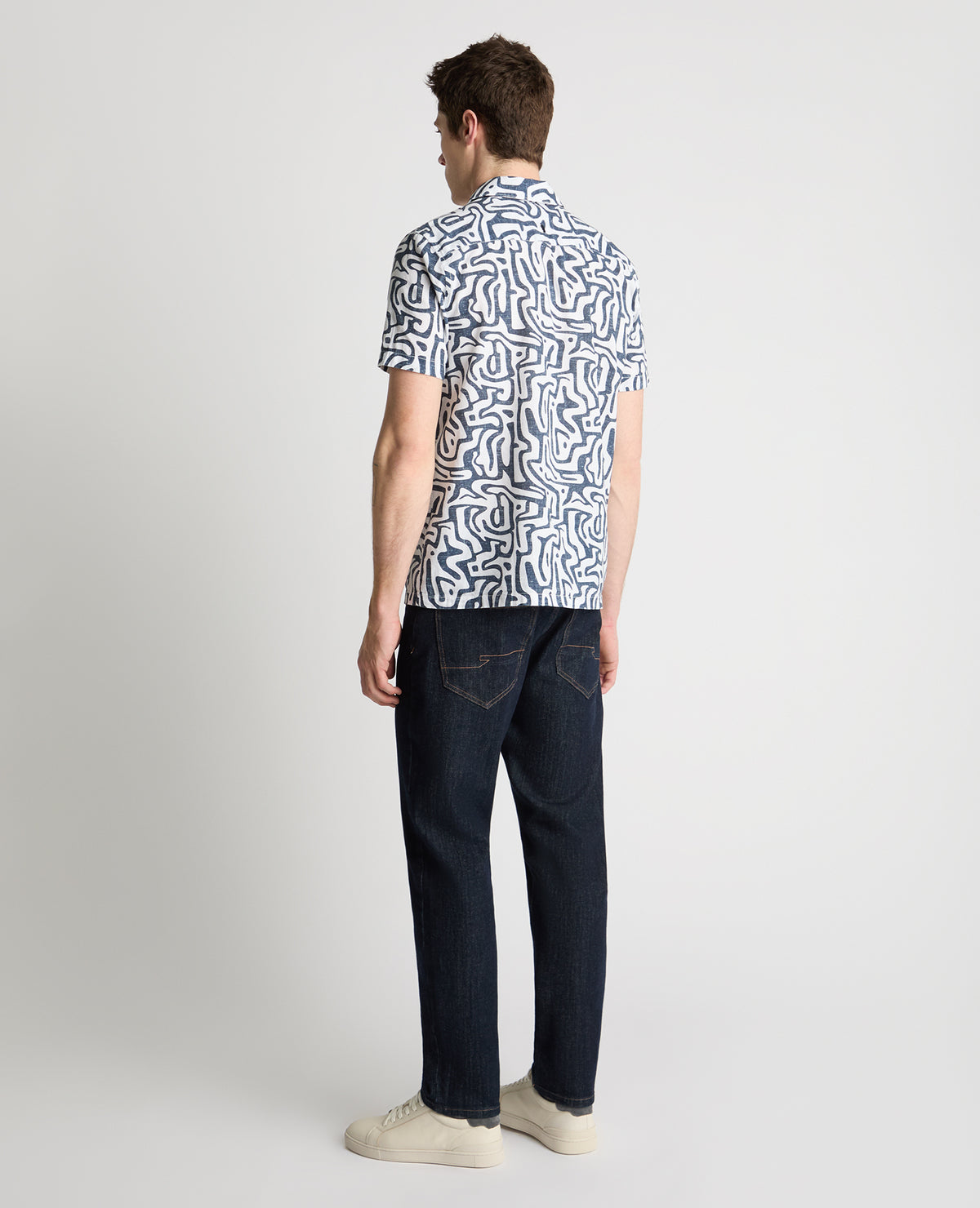 Man wearing a white and navy casual shirt
