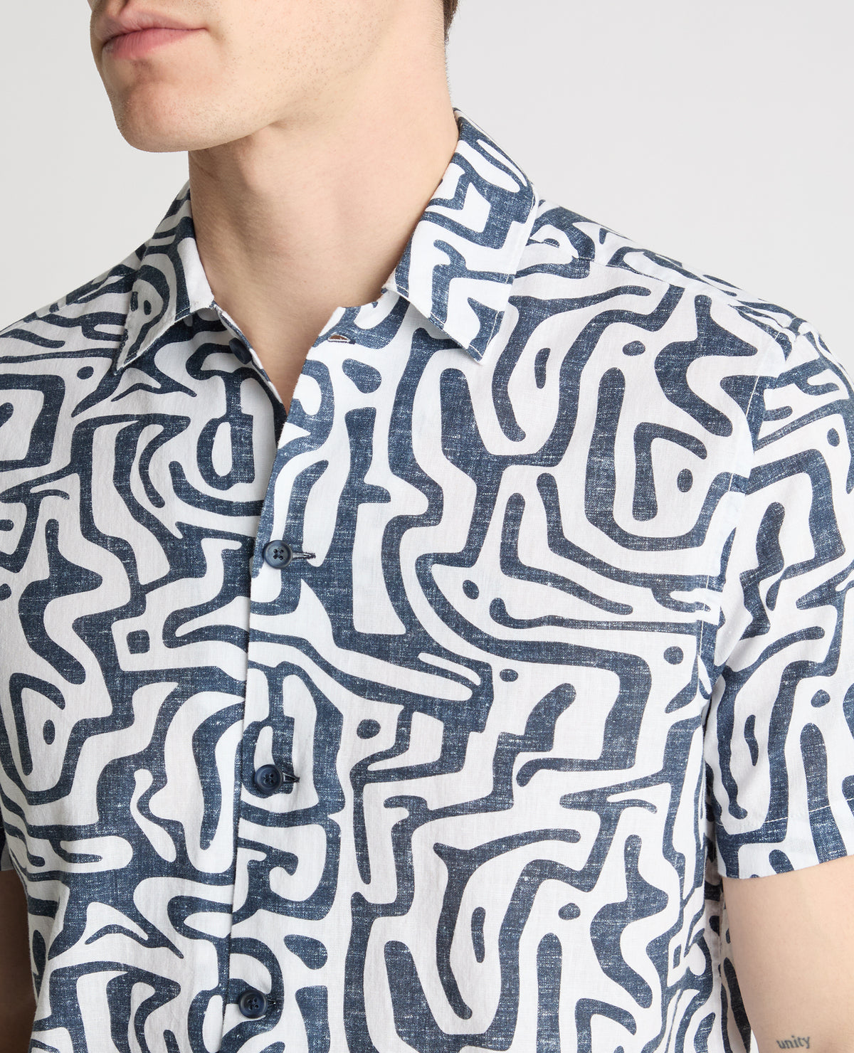 Man wearing a white and navy casual shirt
