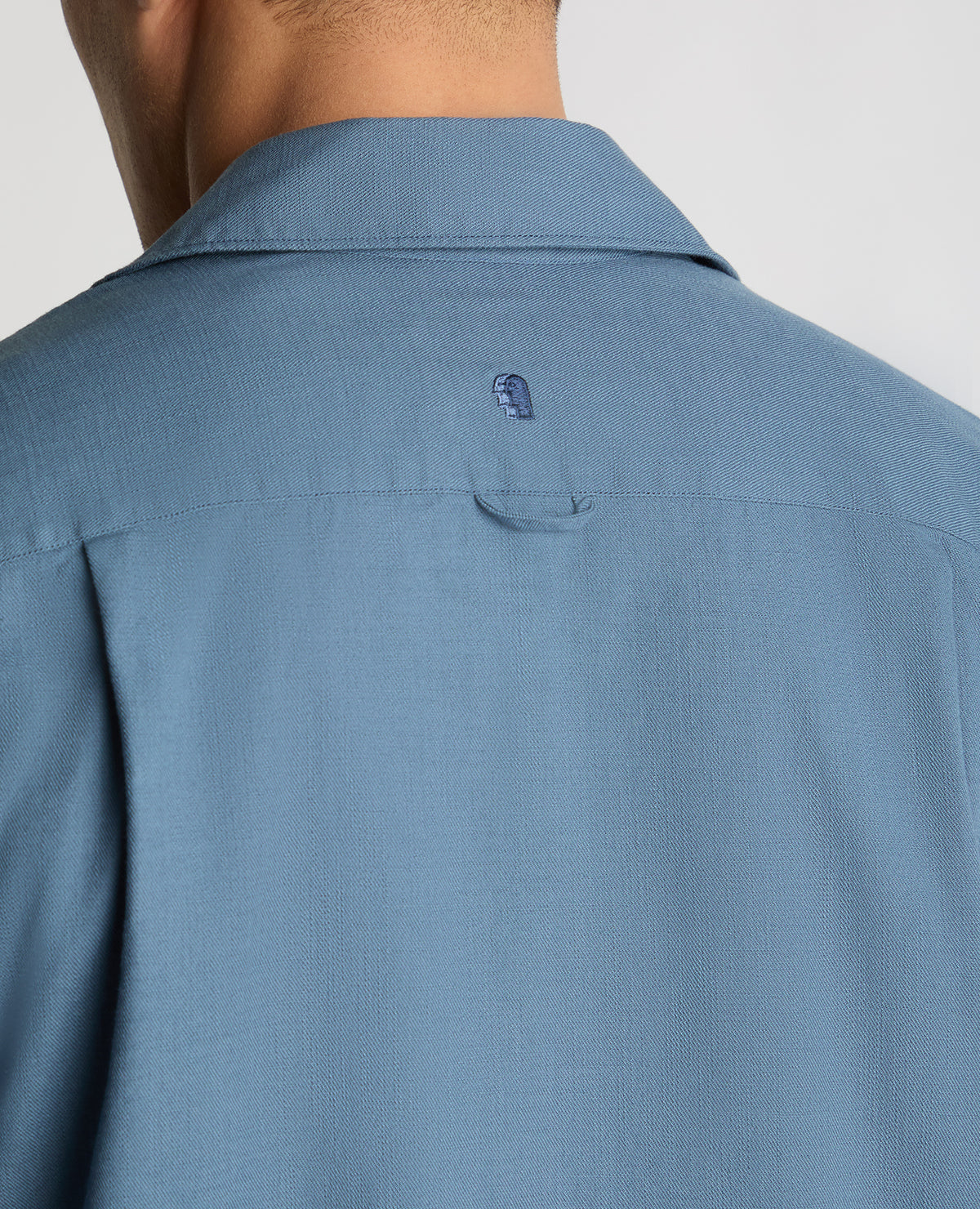 Man wearing a blue casual shirt