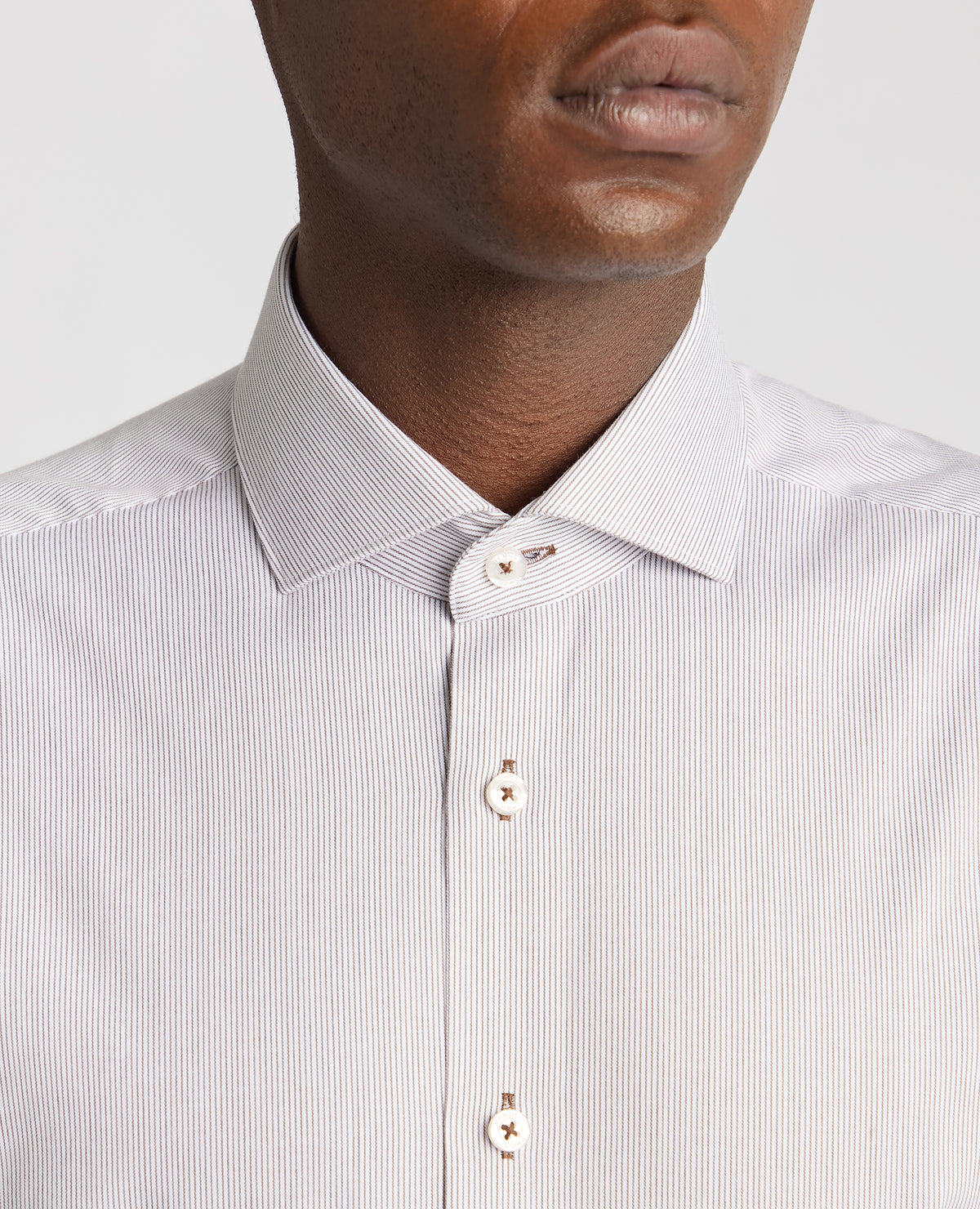 Man wearing a brown Tapered Fit Cotton Stretch Pinstripe Shirt