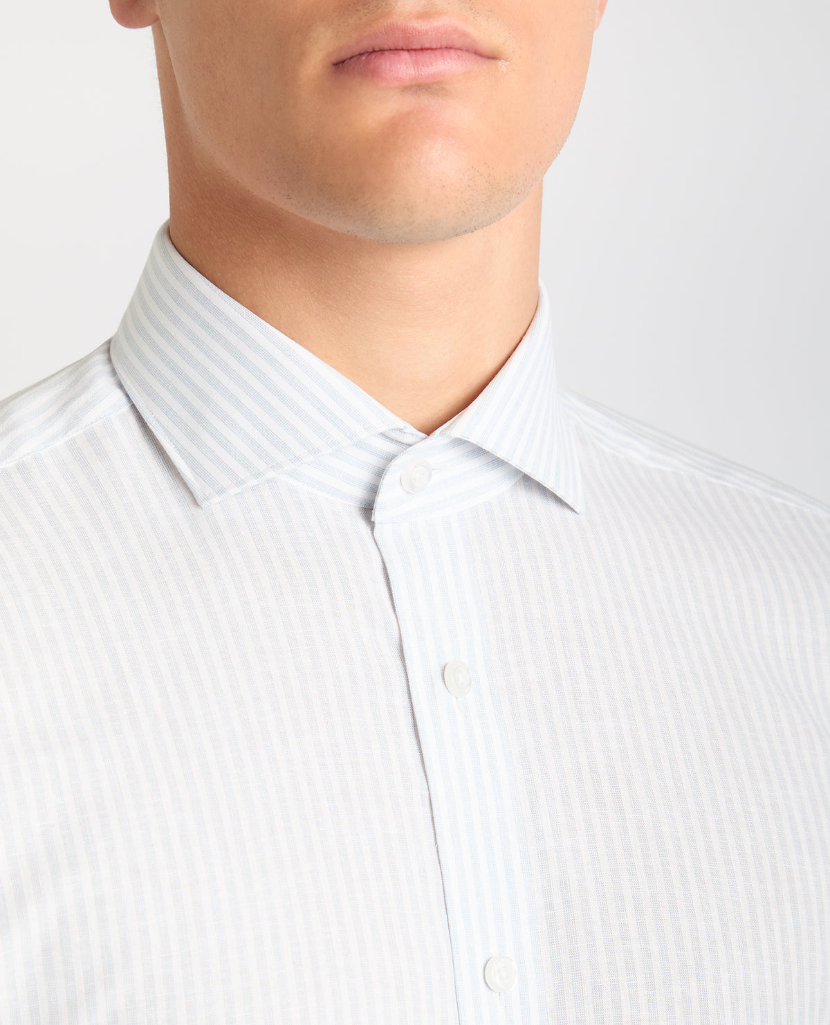 Man wearing a blue Tapered Fit Striped Cotton-Linen Shirt