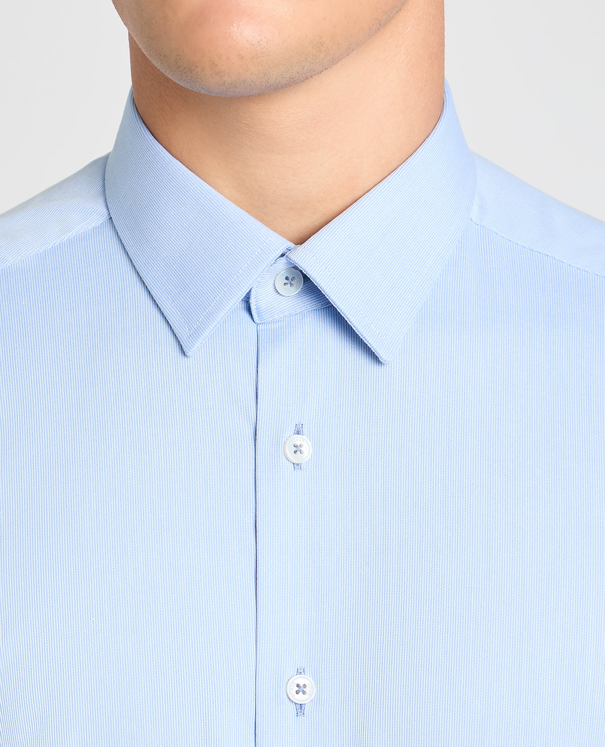 Man wearing a blue formal shirt