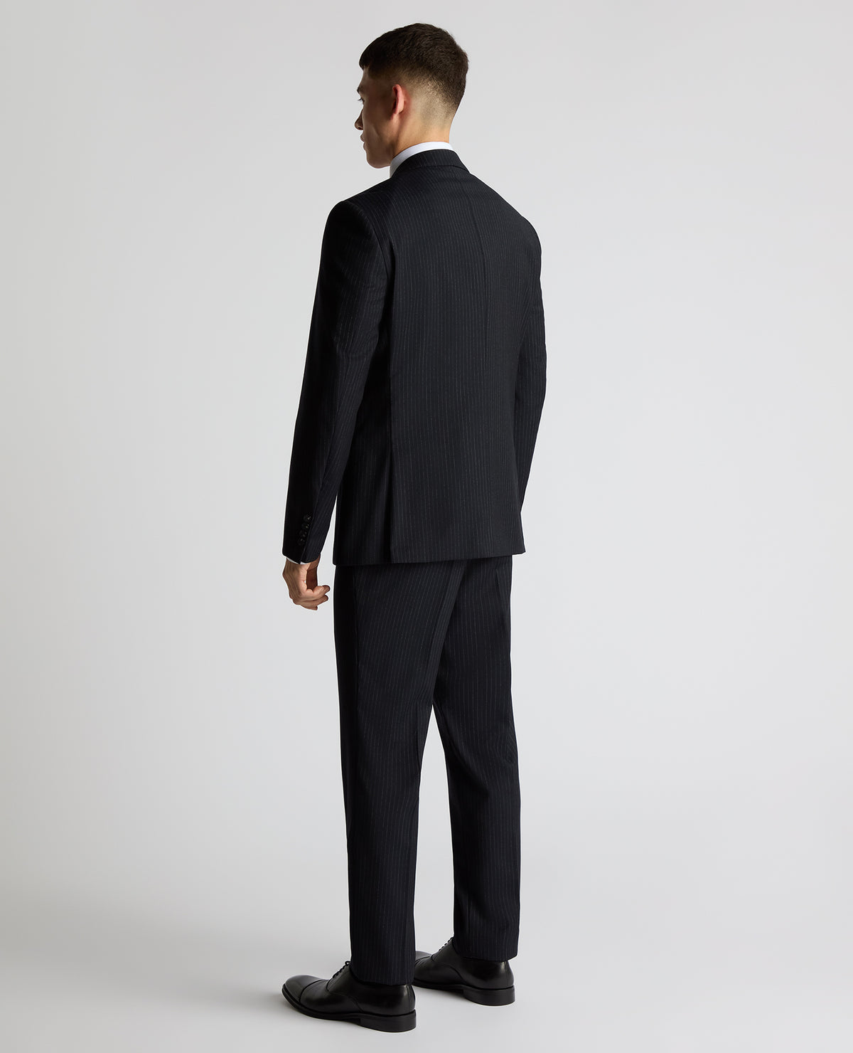 Man wearing a navy Tapered Fit Wool Rich Suit