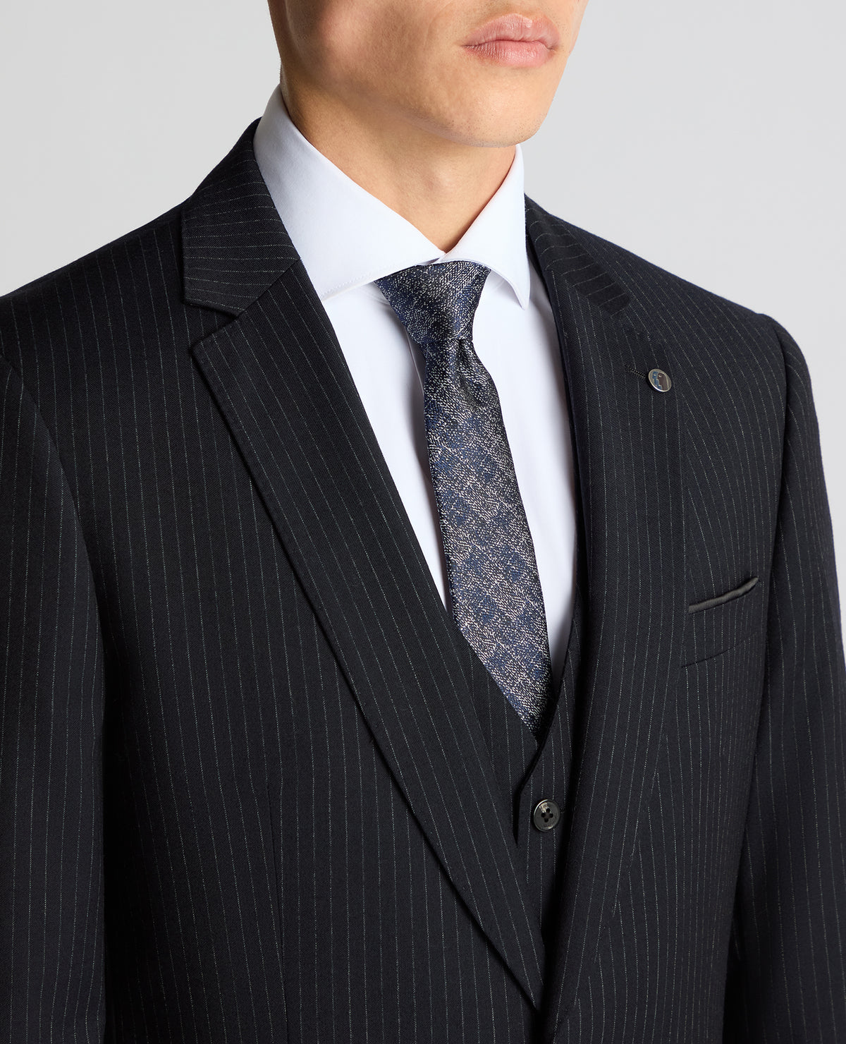Man wearing a navy Tapered Fit Wool Rich Suit