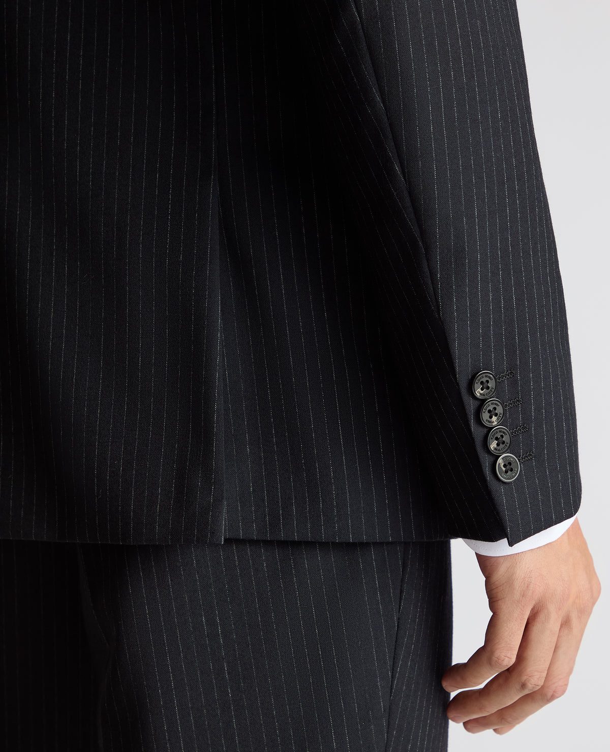 Man wearing a navy Tapered Fit Wool Rich Suit