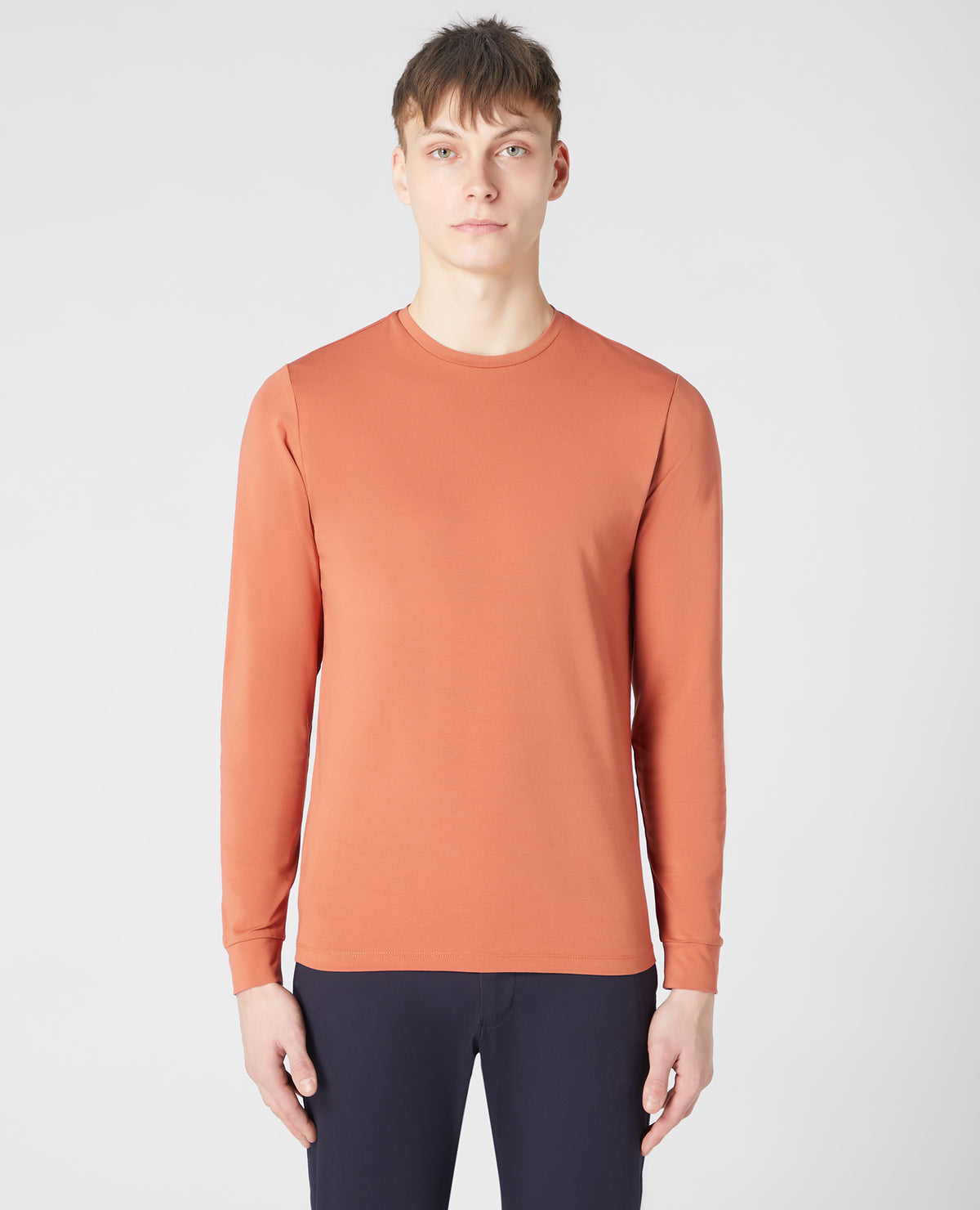 Man wearing a orange Tapered Fit Cotton-Stretch Long Sleeve T-Shirt