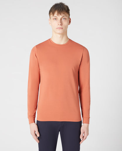 Man wearing a orange Tapered Fit Cotton-Stretch Long Sleeve T-Shirt