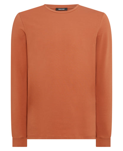 Man wearing a orange Tapered Fit Cotton-Stretch Long Sleeve T-Shirt