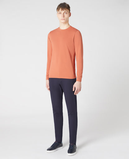 Man wearing a orange Tapered Fit Cotton-Stretch Long Sleeve T-Shirt