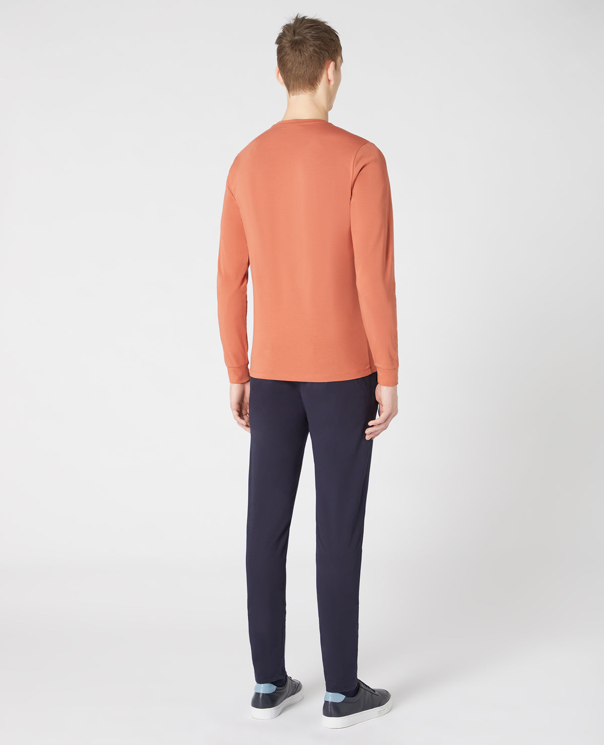 Man wearing a orange Tapered Fit Cotton-Stretch Long Sleeve T-Shirt