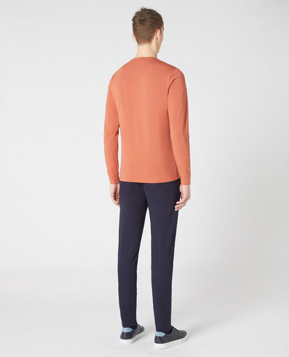 Man wearing a orange Tapered Fit Cotton-Stretch Long Sleeve T-Shirt