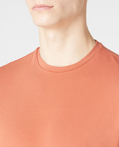 Man wearing a orange Tapered Fit Cotton-Stretch Long Sleeve T-Shirt