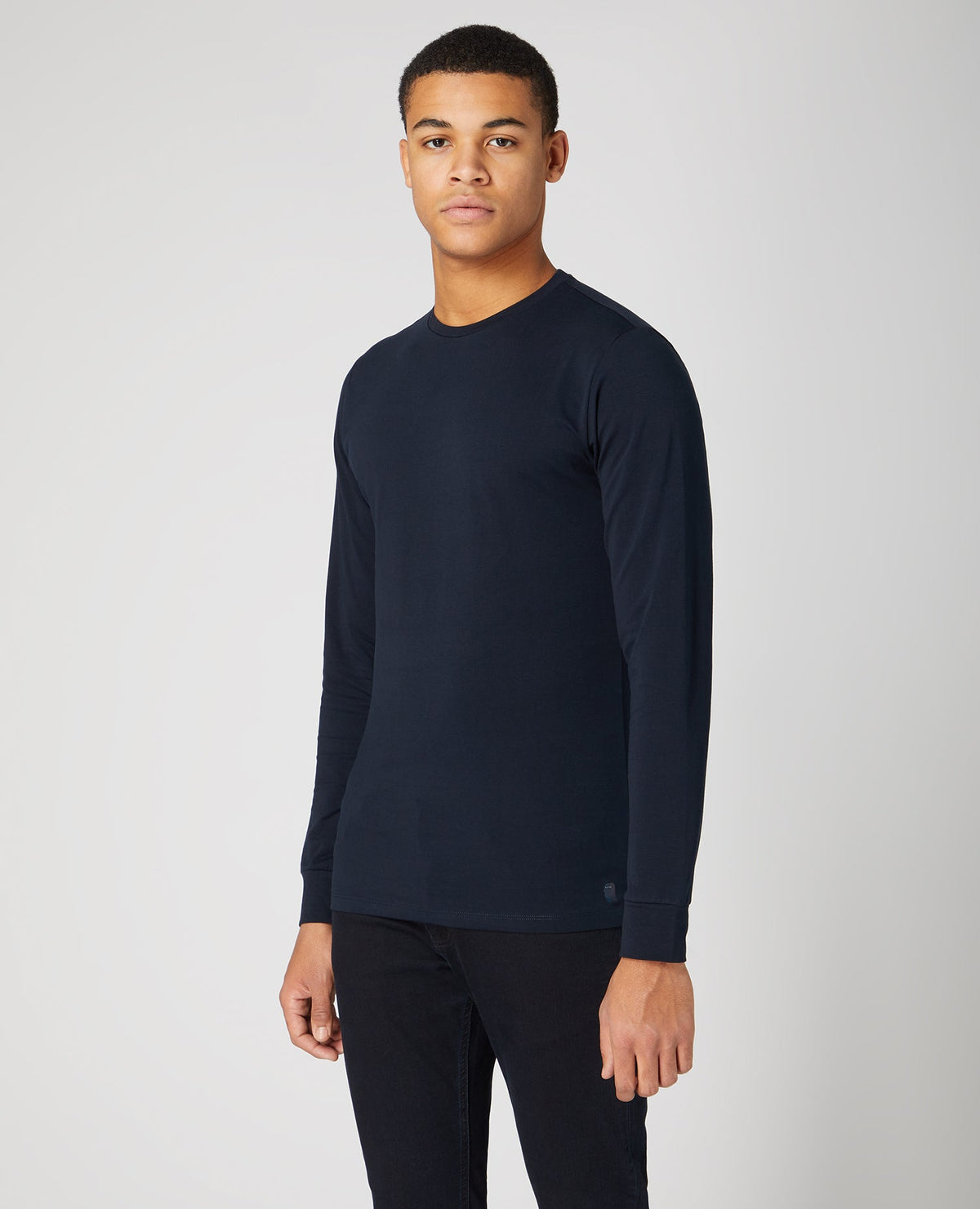 Man wearing a navy Tapered Fit Cotton-Stretch Long Sleeve T-Shirt