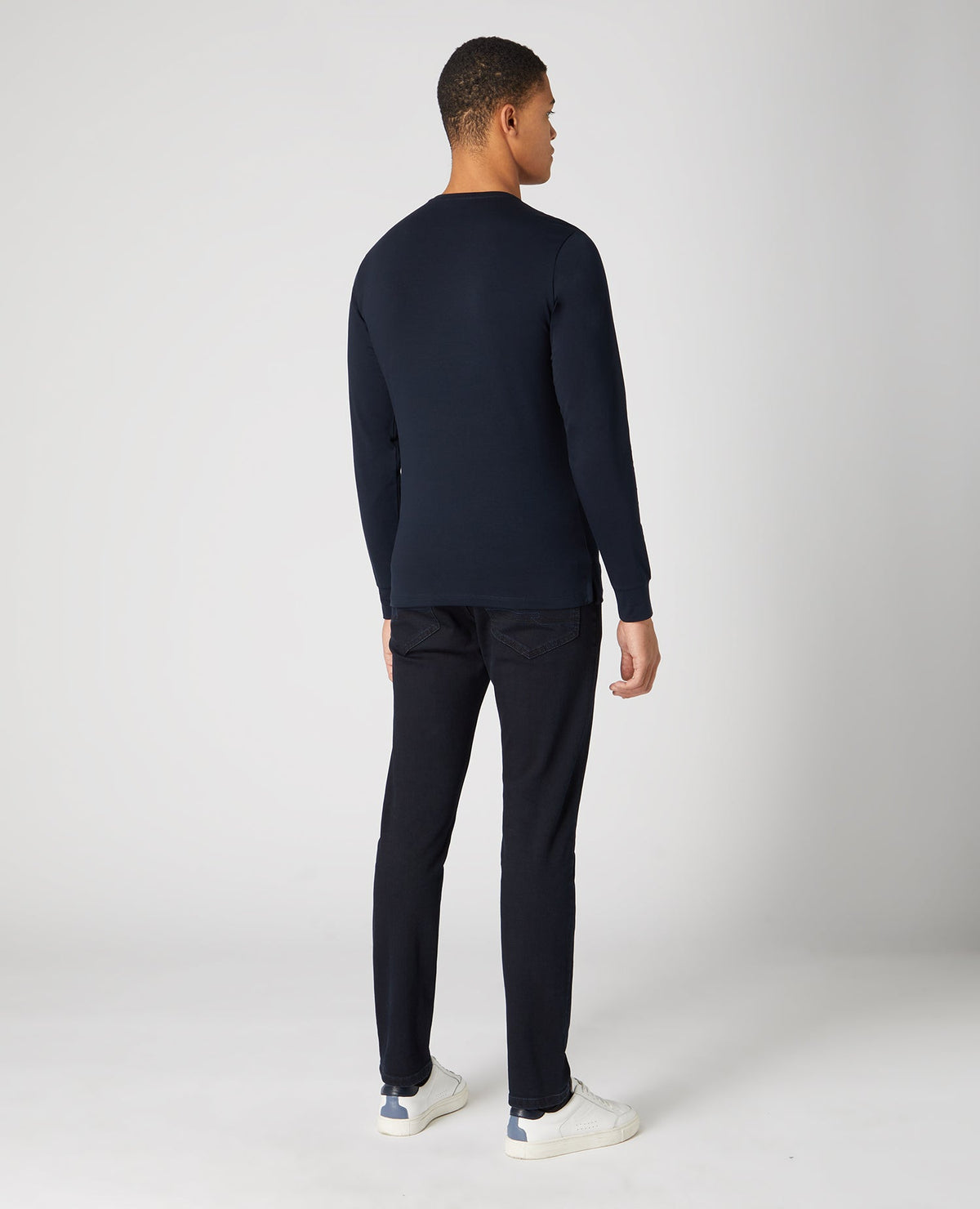 Man wearing a navy Tapered Fit Cotton-Stretch Long Sleeve T-Shirt