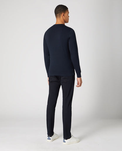 Man wearing a navy Tapered Fit Cotton-Stretch Long Sleeve T-Shirt