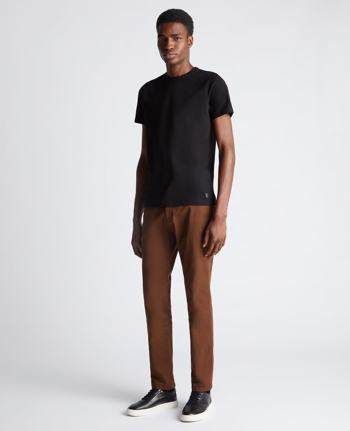 Man wearing a black Tapered Fit Cotton-Stretch T-Shirt