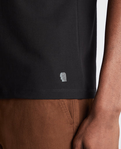 Man wearing a black Tapered Fit Cotton-Stretch T-Shirt