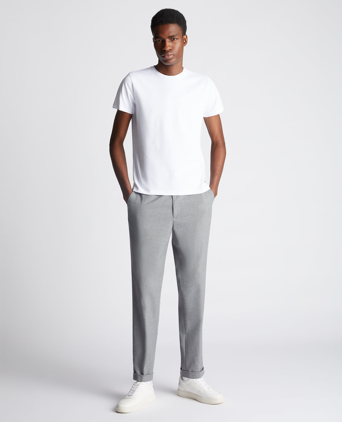Man wearing a white Tapered Fit Cotton-Stretch T-Shirt