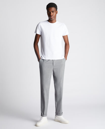 Man wearing a white Tapered Fit Cotton-Stretch T-Shirt